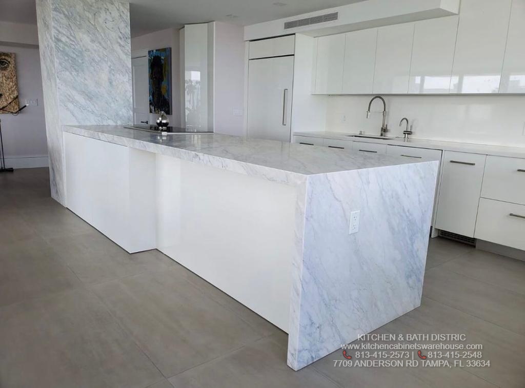White Glossy Kitchen Cabinets &  Carrara Marble Countertop