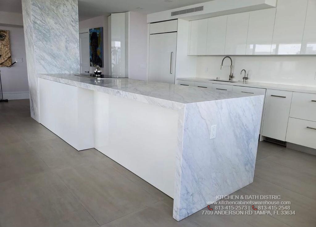 White Glossy Kitchen Cabinets &  Carrara Marble Countertop